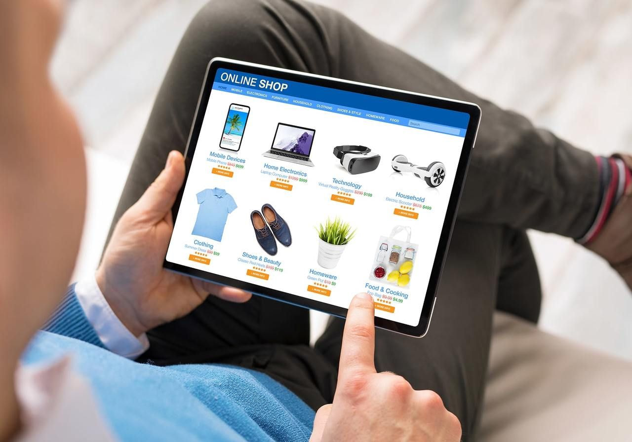 A man is using a tablet for online shopping.